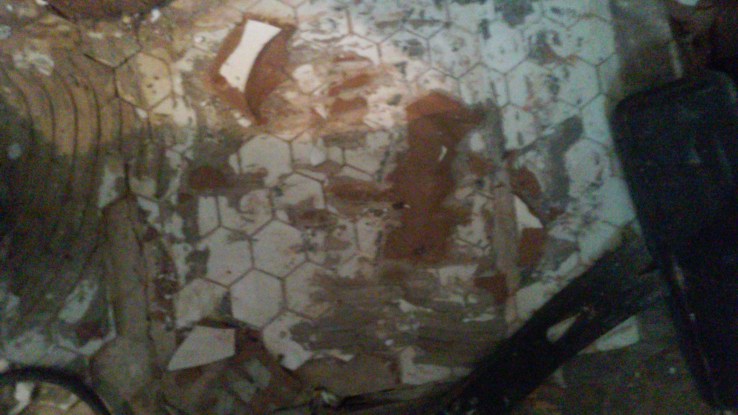 Two layers of tile over a three inch bed of concrete. Couldn't of done it without the aid of my friends demolition hammer.